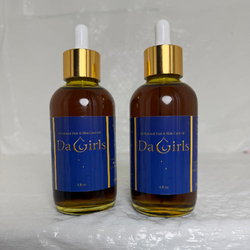 Two bottles of 'Da Girls' product on a white background